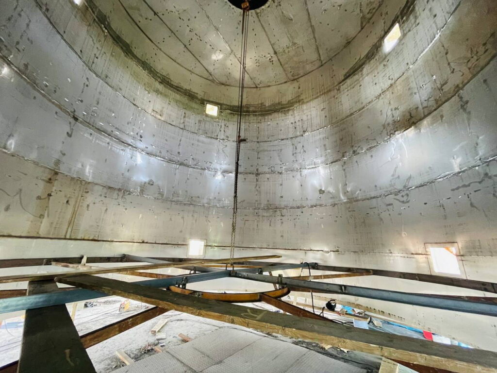 View of the internal upper section of a PAC reactor showing support beams and access ports.
